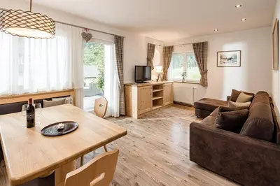 a living room with a table and a couch at Apartment Bellaria in Santa Cristina in Val Gardena