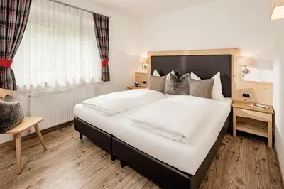 a bedroom with a large bed and a window at Apartment Bellaria in Santa Cristina in Val Gardena