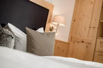 a bedroom with a bed with a pillow and a lamp at Apartment Bellaria in Santa Cristina in Val Gardena