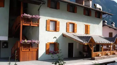 a building with windows and flowers on the balconies at Hotel Miravalle in Imer