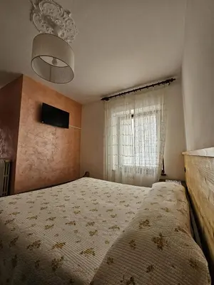 a bedroom with a bed and a window at Hotel Miravalle in Imer