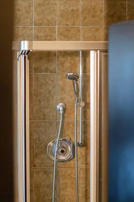 a shower with a shower head in a bathroom at Rooms Kronblick in San Lorenzo di Sebato