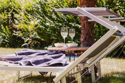 a picnic table with two glasses of wine at Pool House Merano in Merano