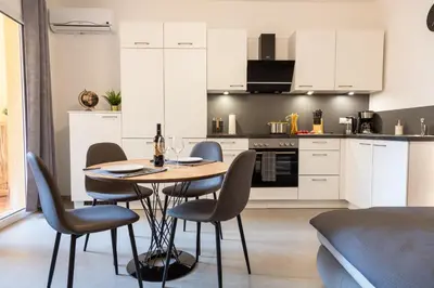 a kitchen and dining room with a table and chairs at Merano City Living in Merano