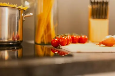 a group of tomatoes on a cutting board on a counter at Merano City Living in Merano