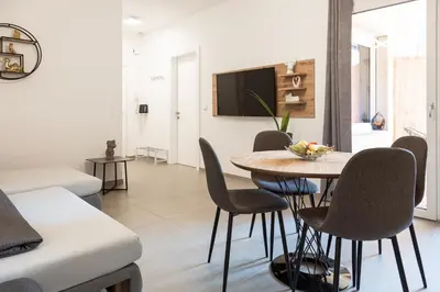 a living room with a table and chairs at Merano City Living in Merano