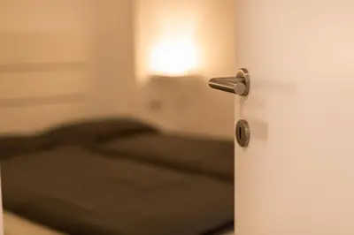 an open door with a bed in a room at Merano City Living in Merano