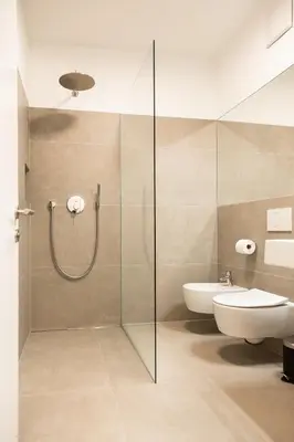 a bathroom with a shower and a toilet and a sink at Merano City Living in Merano