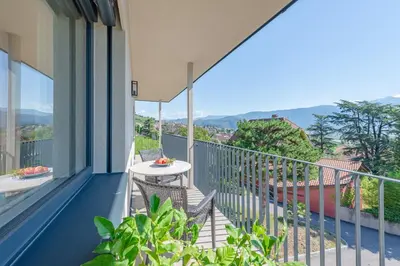 a balcony with a table and chairs at Stürz Ferienwohnungen in Termeno