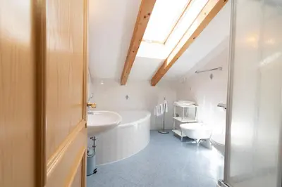 a bathroom with a white tub and a sink at Unterwegerhof in Tires