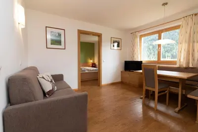 a living room with a couch and a table at Unterwegerhof in Tires
