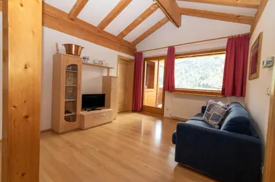 a living room with a couch and a tv at Unterwegerhof in Tires