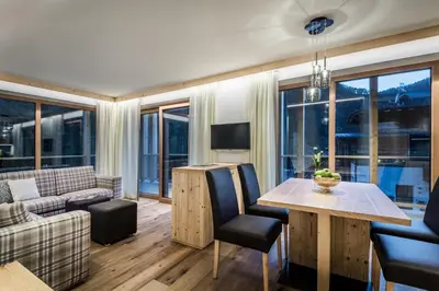 a bedroom with a bunk bed and a desk and a bunk bed at Chalet Martina Apartments in San Vigilio Di Marebbe