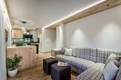 a kitchen with wooden cabinets and a sink at Chalet Martina Apartments in San Vigilio Di Marebbe