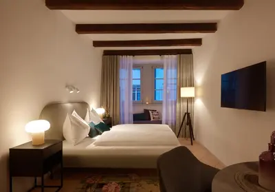 a hotel room with a bed and a window at Binder Apartment in Bolzano