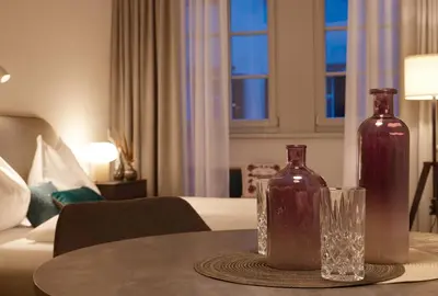 two vases sitting on a table in a hotel room at Binder Apartment in Bolzano