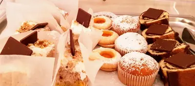 a tray of different types of donuts and desserts at Garni Villa Tyrol - Adults Only in Merano