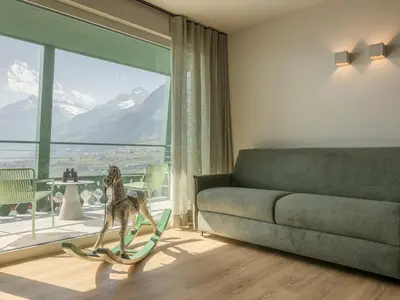 a dog standing on a treadmill in a living room at Pension Höfler - Fernblick in Schenna
