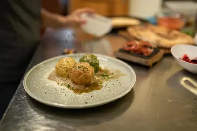 a plate of food on a counter with food at Pension Höfler - Fernblick in Schenna