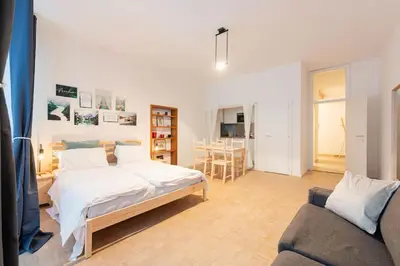 a bedroom with a bed and a couch at Lauben Apartment Bolzano in Bolzano