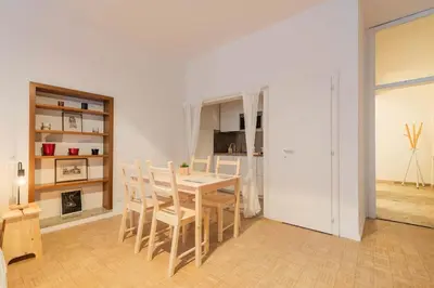 a kitchen and dining room with a table and chairs at Lauben Apartment Bolzano in Bolzano