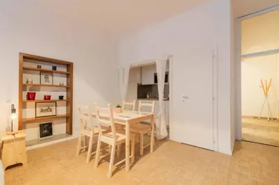 a kitchen and dining room with a table and chairs at Lauben Apartment Bolzano in Bolzano