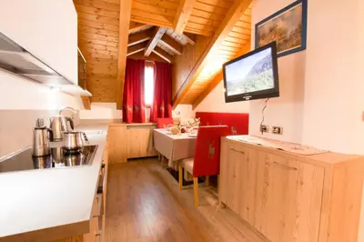 a bedroom with a bed with red pillows on it at Residence Villa Artic in Campitello di Fassa