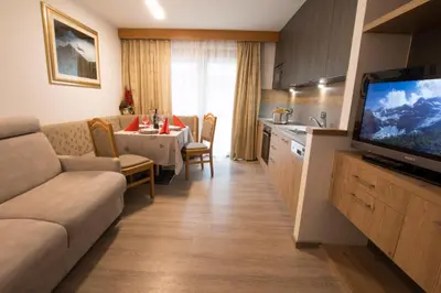 a room with a staircase with a living room at Residence Villa Artic in Campitello di Fassa