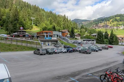 a bunch of cars parked in a parking lot at Ciasa Molino 306 in Falcade