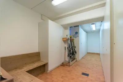 a hallway in an office building with a door at Ciasa Molino 306 in Falcade