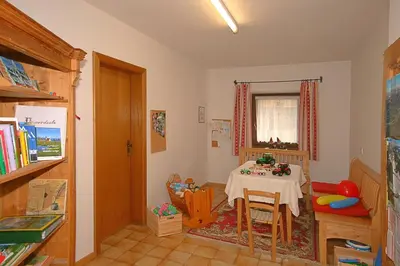 a dining room with a table and a table and chairs at Ferienwohnungen Bulandhof in Valdaora