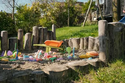 a pile of toys in the sand in a sandbox at Oberwirtshof in Rifiano