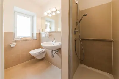 a bathroom with a sink and a toilet and a shower at Oberwirtshof in Rifiano