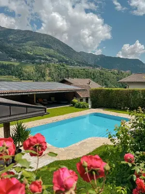 a swimming pool in the yard of a house at Oberwirtshof in Rifiano