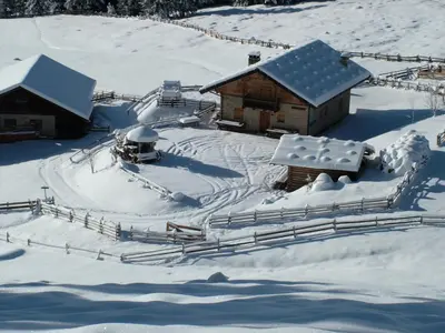an aerial view of a snow covered cabin at Rastlhof in Meltina