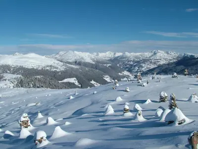 a group of people skiing down a snow covered mountain at Rastlhof in Meltina