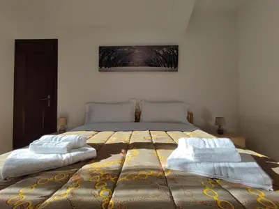 a bedroom with a bed with two pillows on it at Hotel TEA DOLOMITI - Lago di Alleghe - Monte Civetta in Alleghe
