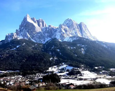 a mountain with a town in front of it at Villa Bernhard in Siusi