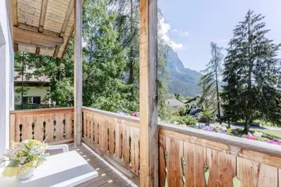 a view from the porch of a house with a large window at Villa Bernhard in Siusi