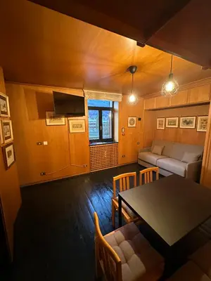a living room with a table and a couch at Harmony Apartment 31 in San Martino di Castrozza