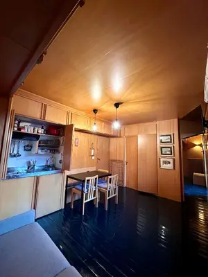 a kitchen with a table and chairs in a room at Harmony Apartment 31 in San Martino di Castrozza