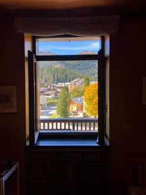a window in a room with a view of a town at Harmony Apartment 31 in San Martino di Castrozza
