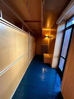 an empty hallway with a bench and a window at Harmony Apartment 31 in San Martino di Castrozza