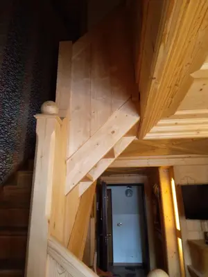 a wooden stairway with a wooden stair case in a house at Precumon 16/5 in Arabba