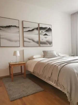 a bedroom with a bed and four pictures on the wall at Charmante Wohnung in Zentrum von Nals in Nalles