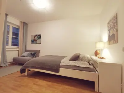 a bedroom with a bed and a couch in it at Charmante Wohnung in Zentrum von Nals in Nalles