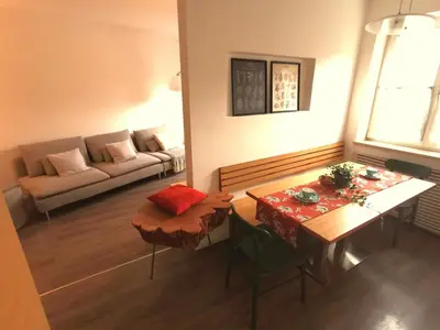 a living room with a table and a couch at Charmante Wohnung in Zentrum von Nals in Nalles