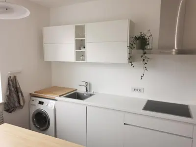 a white kitchen with a sink and a washing machine at Charmante Wohnung in Zentrum von Nals in Nalles