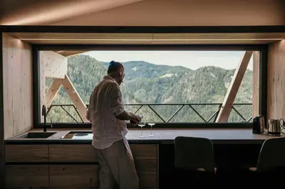 a man standing in front of a large window at Aparthotel My Daum in Nova Ponente