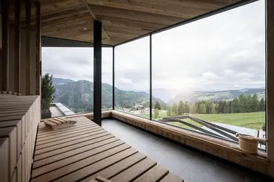a room with a large window with a view of mountains at Aparthotel My Daum in Nova Ponente